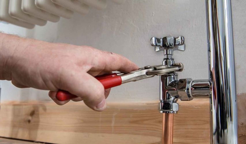 Careers at Westcal Property mangement are diverse. This is a picture of a maintenance person fixing a plumbing fixture